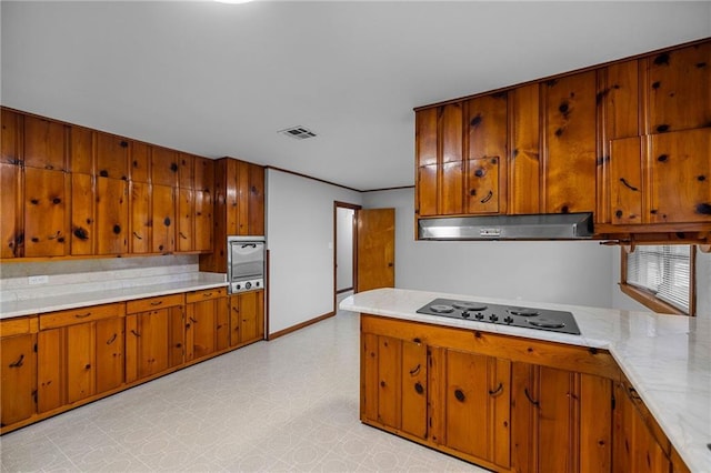 kitchen with oven, exhaust hood, and electric stovetop