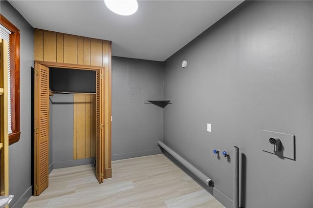 laundry area with light hardwood / wood-style floors