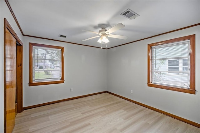 spare room with light hardwood / wood-style floors, ceiling fan, and crown molding