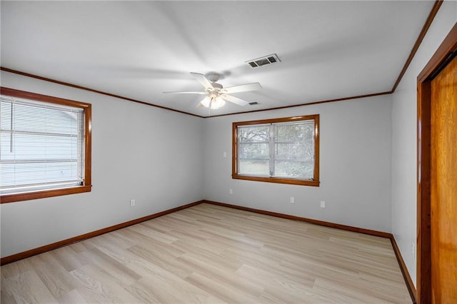 unfurnished bedroom with multiple windows, light hardwood / wood-style floors, ceiling fan, and ornamental molding