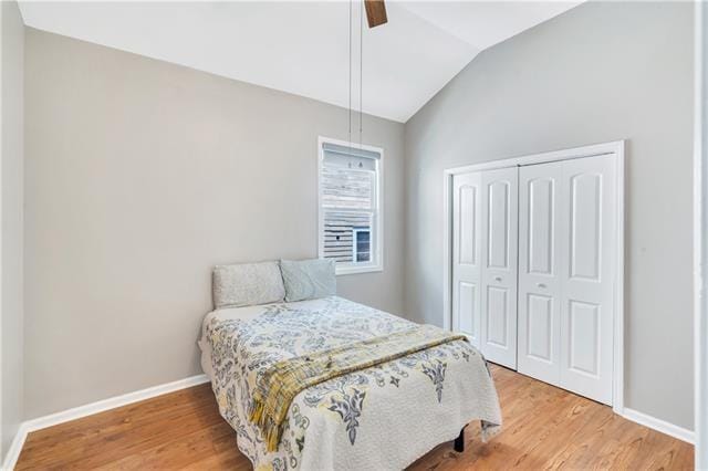 bedroom with a closet, vaulted ceiling, ceiling fan, and hardwood / wood-style flooring