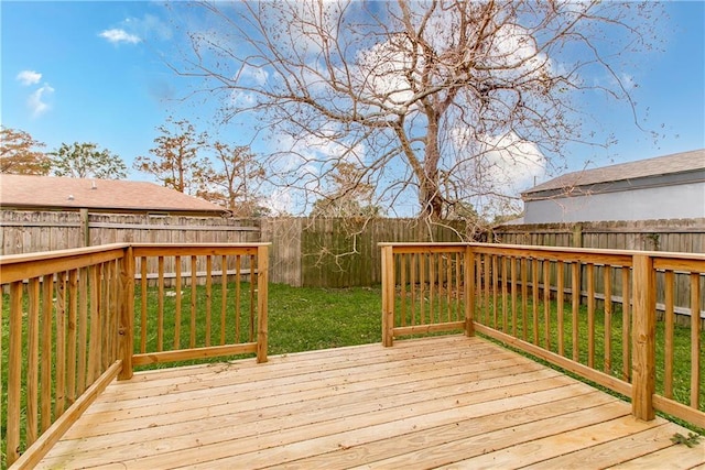 wooden terrace featuring a lawn