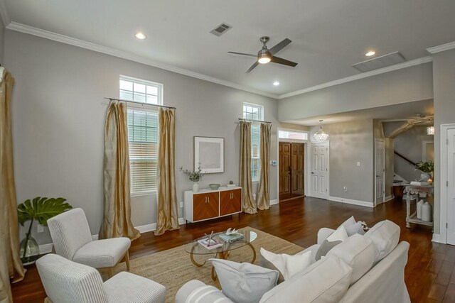 living room featuring ceiling fan, ornamental molding, and dark hardwood / wood-style flooring