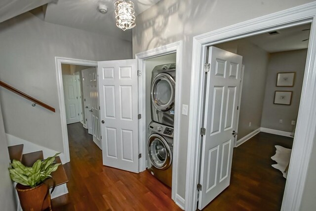 washroom with stacked washer and dryer and dark hardwood / wood-style floors