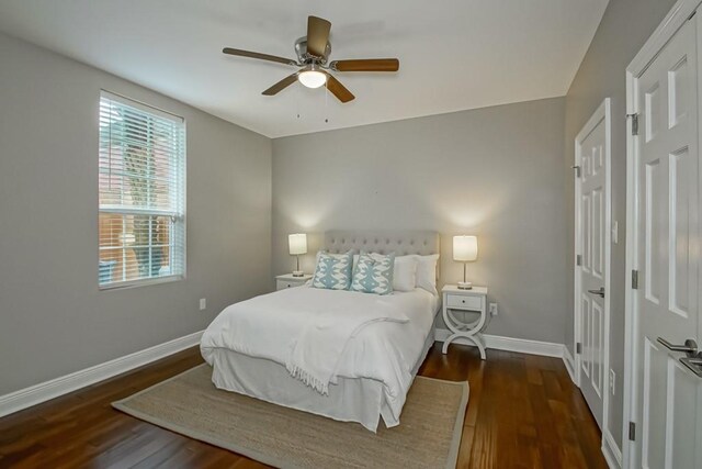 bedroom with ceiling fan and dark hardwood / wood-style flooring