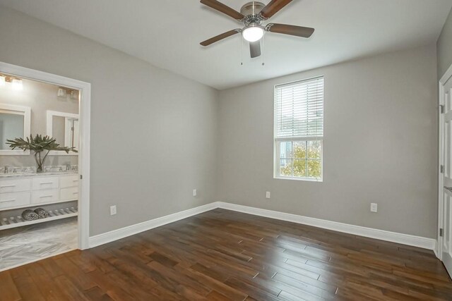 unfurnished bedroom with connected bathroom, ceiling fan, and dark hardwood / wood-style flooring