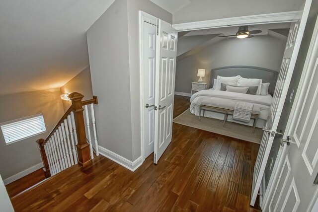 bedroom with vaulted ceiling and dark hardwood / wood-style flooring