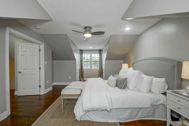 bedroom with ceiling fan, vaulted ceiling, and dark hardwood / wood-style flooring