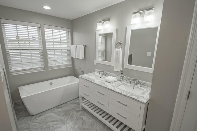 bathroom with vanity and a bath