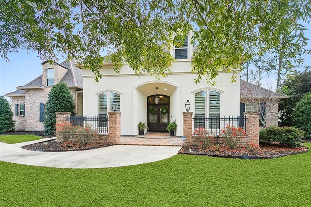 view of front of home featuring french doors and a front lawn