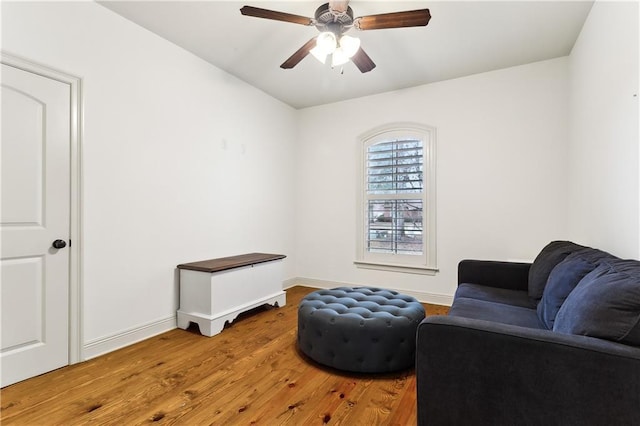 living area featuring ceiling fan and hardwood / wood-style flooring