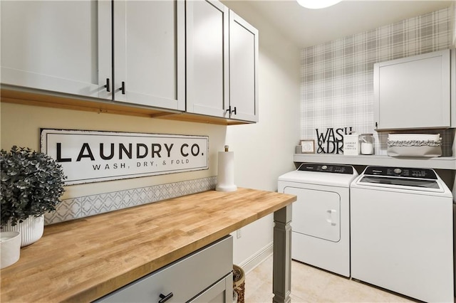 laundry area with cabinets and washing machine and clothes dryer