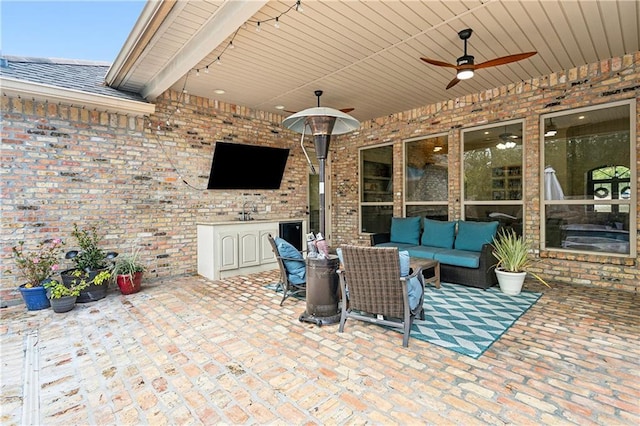 view of patio / terrace featuring an outdoor living space, sink, and ceiling fan