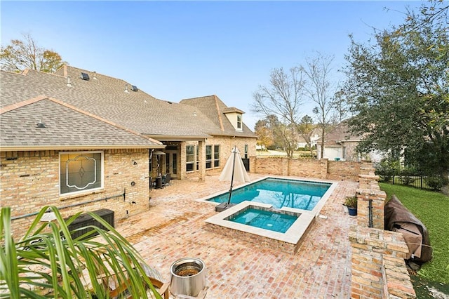 view of swimming pool with an in ground hot tub