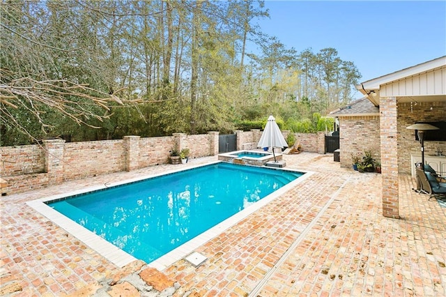 view of pool with an in ground hot tub and a patio area