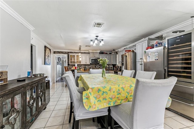 tiled dining space featuring crown molding