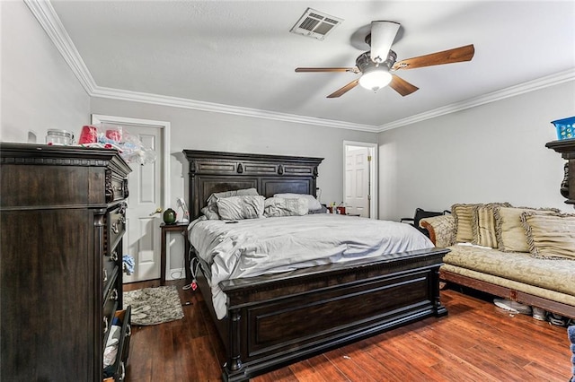 bedroom with dark hardwood / wood-style floors, ceiling fan, and ornamental molding