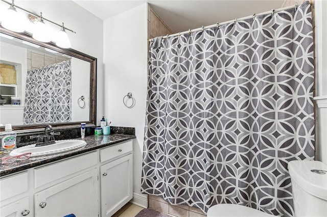 bathroom with tile patterned floors, vanity, and toilet