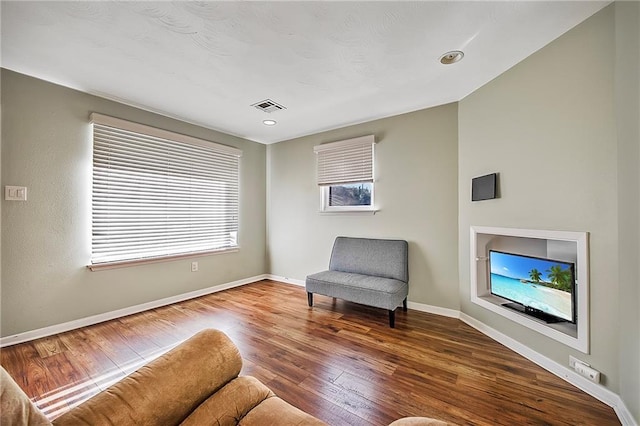 living area with hardwood / wood-style floors