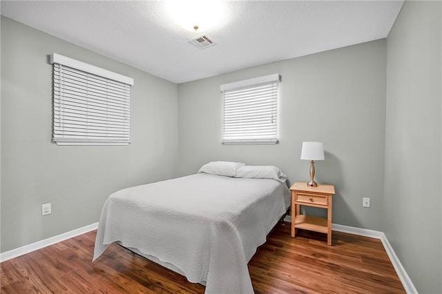 bedroom featuring dark hardwood / wood-style floors