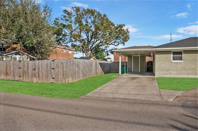 exterior space featuring a carport and a lawn