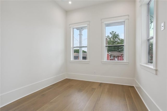 unfurnished room featuring hardwood / wood-style flooring