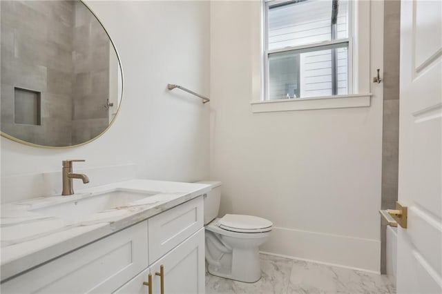 bathroom with vanity, toilet, and walk in shower