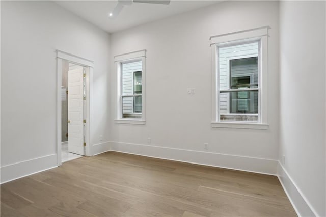 empty room featuring ceiling fan and light hardwood / wood-style flooring