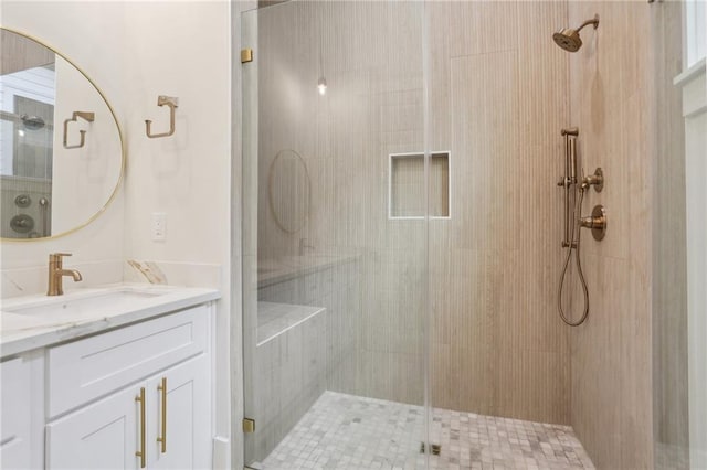 bathroom featuring vanity and an enclosed shower