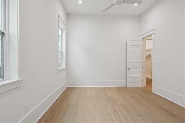 spare room featuring ceiling fan and light wood-type flooring