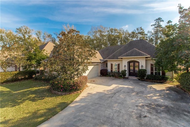 view of front of house with french doors, a front lawn, and a garage