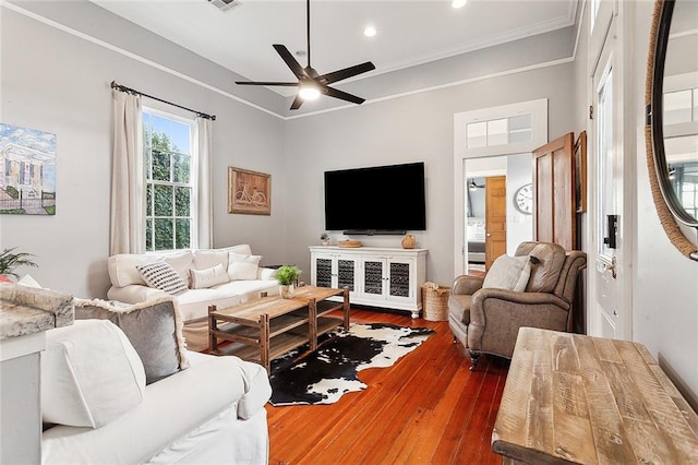 living room featuring ceiling fan, dark hardwood / wood-style floors, and ornamental molding