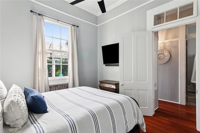 bedroom with radiator, dark hardwood / wood-style floors, ceiling fan, and crown molding