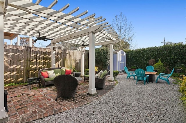 view of patio with an outdoor living space, a storage unit, and a pergola