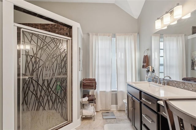 bathroom featuring vanity, an enclosed shower, and vaulted ceiling