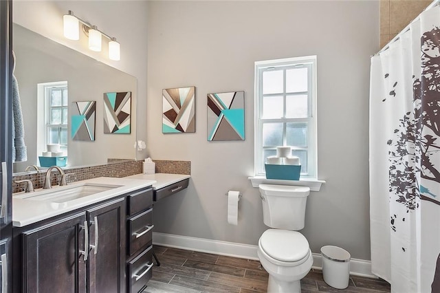 bathroom featuring a shower with curtain, vanity, and toilet