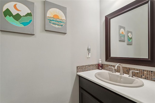 bathroom with vanity and tasteful backsplash