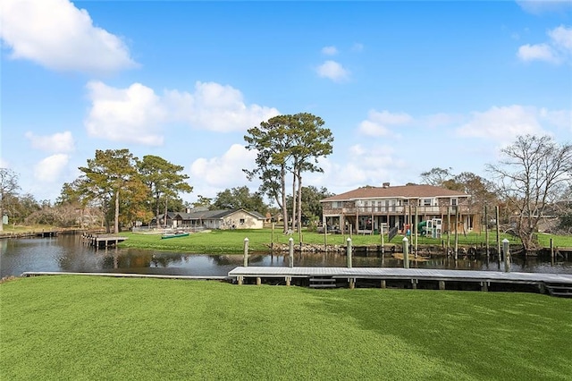 view of dock featuring a lawn and a water view