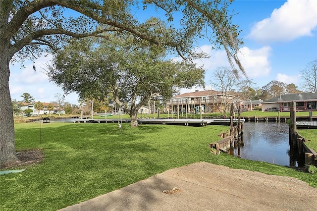 dock area with a yard and a water view