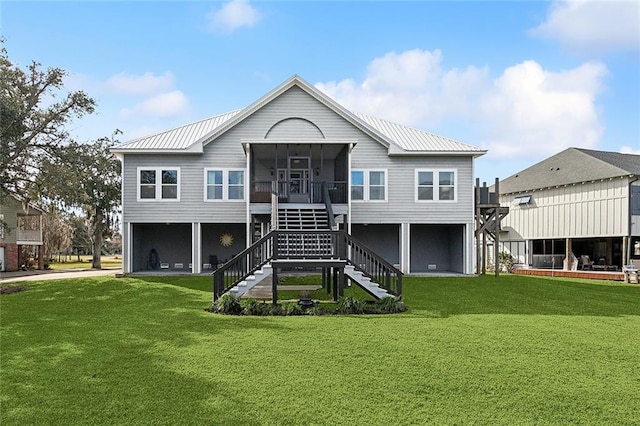 back of property featuring a lawn and a sunroom