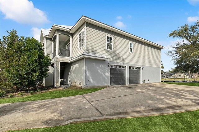 view of property exterior featuring a garage and a balcony