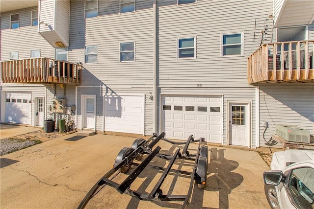 rear view of property featuring a garage