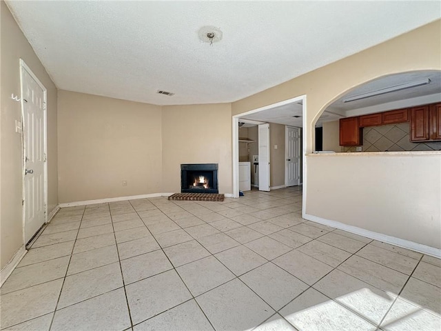 unfurnished living room featuring light tile patterned flooring