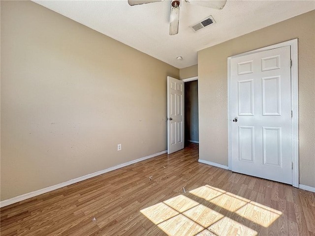 unfurnished bedroom featuring ceiling fan and light hardwood / wood-style flooring