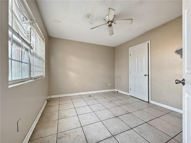 unfurnished room featuring light tile patterned floors and ceiling fan