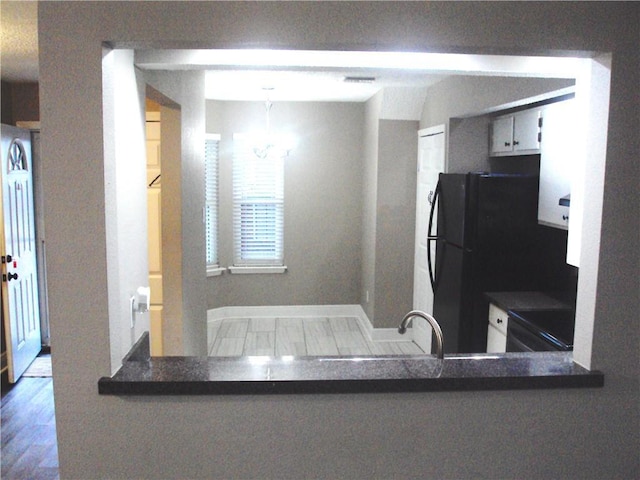 kitchen with wood-type flooring, sink, range, and kitchen peninsula