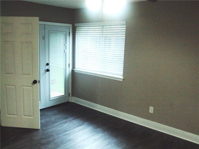 unfurnished room featuring dark hardwood / wood-style flooring