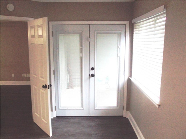 entryway with plenty of natural light, dark hardwood / wood-style floors, and french doors