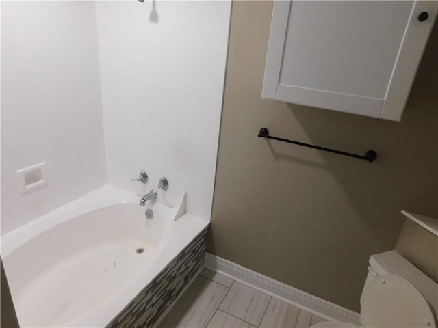 bathroom with a bathing tub and toilet