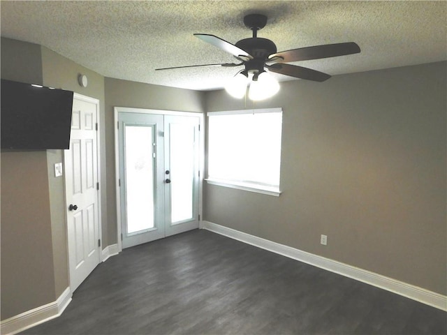 interior space with ceiling fan, dark wood-type flooring, a textured ceiling, and french doors